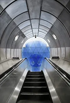 Escalator: Underground - view up escalator to a geodesic glass screen