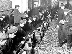 Dole: Unemployed men in London chopping sticks for firewood