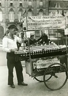 Begging: Unemployed sailor with his model ship in front