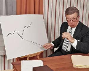 Profits: Unhappy Business Man Looking at Camera Pointing to