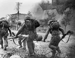 Litters: United Nations forces carry a soldier wounded