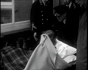 Mitford: Unity Mitford Lying on a Stretcher and Covering