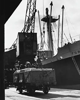 Anchored: Unloading cargo from a large steamship in Manchester Docks