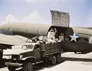 Pickup: Unloading cargo from a U.S. Army Air Transport
