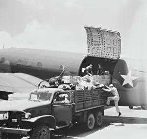 Freight: Unloading cargo from a U.S. Army Air Transport
