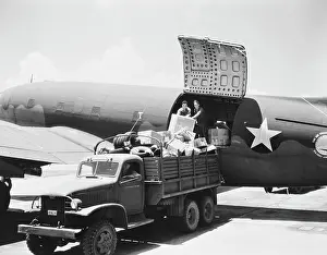Freight: Unloading cargo from a U.S. Army Air Transport