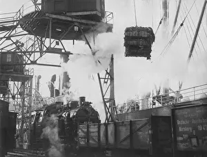 Approximately: Unloading a shipment of cotton in the harbor of Bremen, 1933
