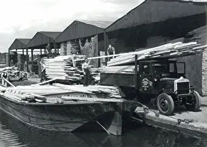 Unfamiliar: UNLOADING TIMBER 1930S