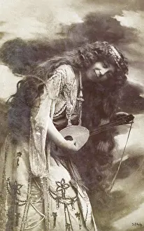 Tuning: Unusual woman playing a small stringed instrument