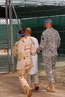 Detainee: U.S. Army and Navy guards escort a detainee ?