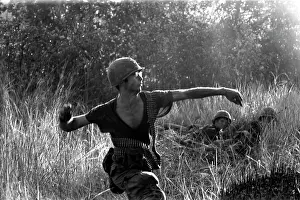Stocktrek Images: U.S. Army soldier hurls a grenade at an enemy