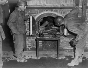 Lcgr1403: Three U.S. Army soldiers looking at bodies in