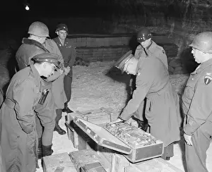 Currencies: U.S. commanders examine a suitcase of silverware