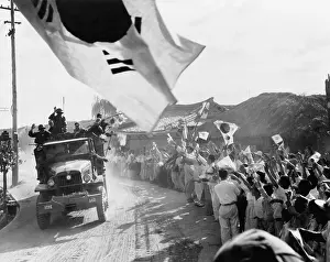 East Asia: U.S. First Cavalry Division troops pass cheering