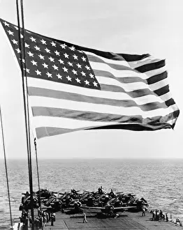 Slower: U.S. flag waving in foreground over flight ?