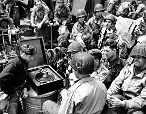 Lcgr1407: U.S Infantrymen listen to a phonograph on their
