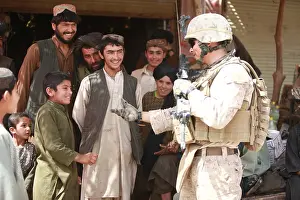 Afghans: A U.S. Marine talks with Afghans in the ?