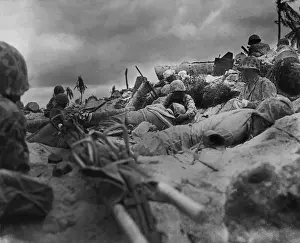 Galvanic: U.S. Marines take cover from Japanese fire behind