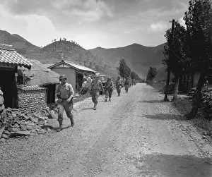North Koreans: U.S. Marines pass through one of the many small