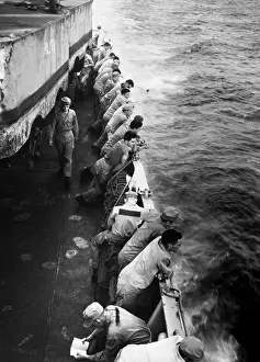 Reinforcement: U.S. Marines stand along the rail of the USS Clymer