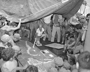 Hopping: U.S. Marines study a relief map on Guam before