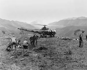 Medical Care: U.S. Navy Corpsmen prepare three Marines for evacuation