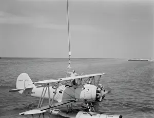 Warplane: A U.S. Navy N3N seaplane being attached to