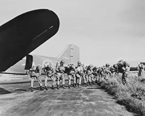 Inspecting: U.S. paratroopers checking their parachutes