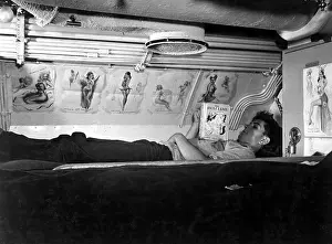 Submariners: U.S. sailor reading in his bunk aboard USS CAPELIN