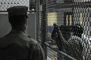 Guantanamo: U.S. Sailor stands watch over a cell block ?