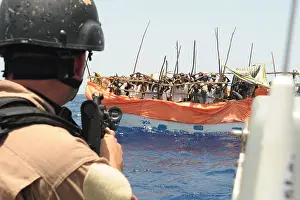 Rickety: U.S. Sailor trains his gun on over twenty ?