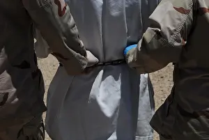 Guantanamo: U.S. Sailors both grasping the chain around ?