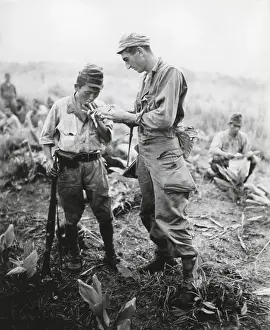 Socializing: U.S. soldier of lights a cigarette for a former