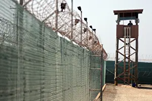 Guantanamo: U.S. Soldier stands watch in a guard tower ?