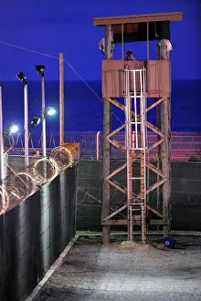 Guantanamo: U.S. Soldier stands watch in a guard tower ?