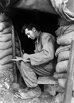 Left Handed: U.S. soldier writes a letter during a break along