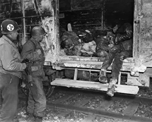 Deliberately: Two U.S. soldiers looking at dead prisoners on