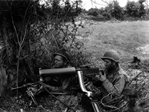 Hedgerows: Two U.S. soldiers positioned in a Normandy hedgerow