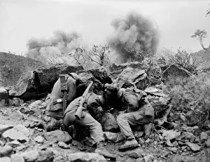 Dauntless: U.S. soldiers behind rocks to shield themselves