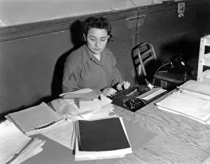 Plywood: U.S. WAC Private First Class typing at a rough