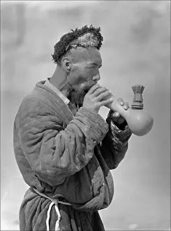 Smokes: A Uyghur man smoking an elaborate pipe