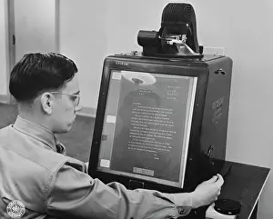 Inspecting: V-mail is inspected for flaws on an enlarging