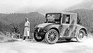Hanomag: Vacationer next to small car on a mountain road, around the
