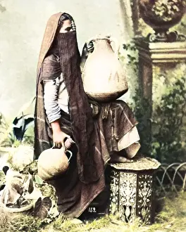 Veiled: Veiled woman with pots, Egypt