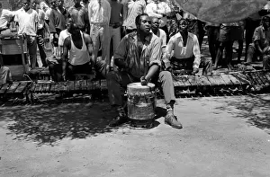 Mbande: Venancio Mbande playing nzoma drum during entry movement