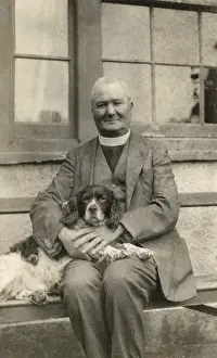 Vicars: Vicar with a spaniel dog on a bench