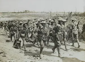 Returning: Vickers machine-gun team marching past a working party