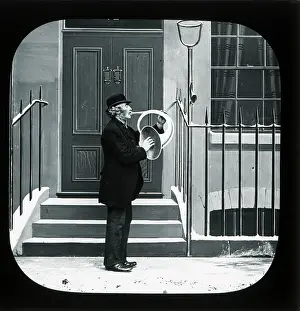 Railings: Victorian horn player in a street