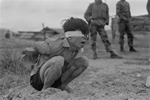 Helpless: Viet Cong prisoner of war. A terrified VC ?