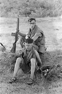 Quang: Vietnam War. A US Marine corporal guards ?